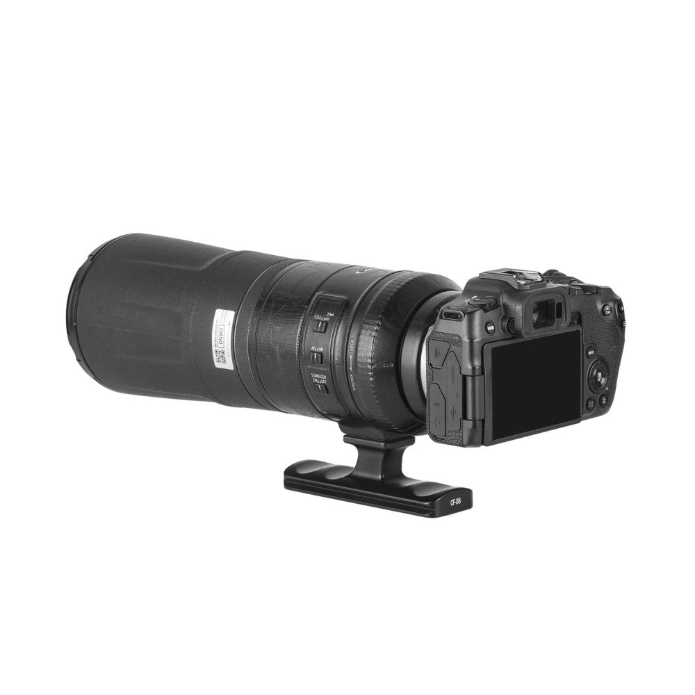 Side view of a telephoto lens mounted on a camera body with a black tripod foot attachment underneath.