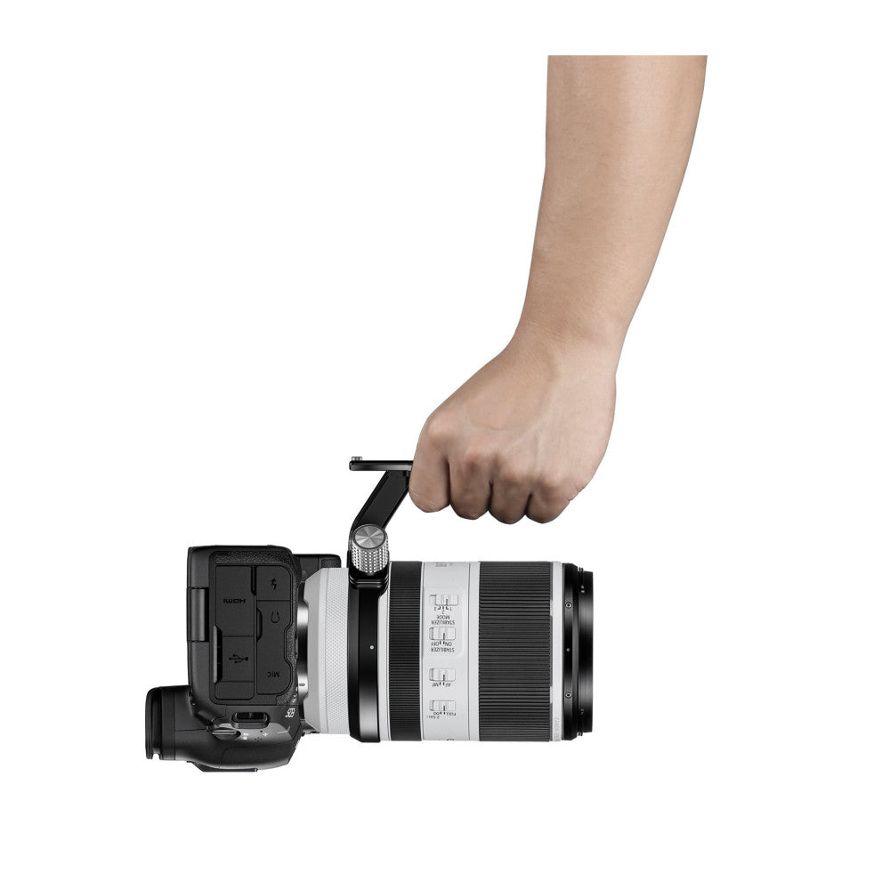 Hand demonstrating the use of a black lens collar attachment on a Canon RF 70-200mm telephoto lens mounted on a camera body.