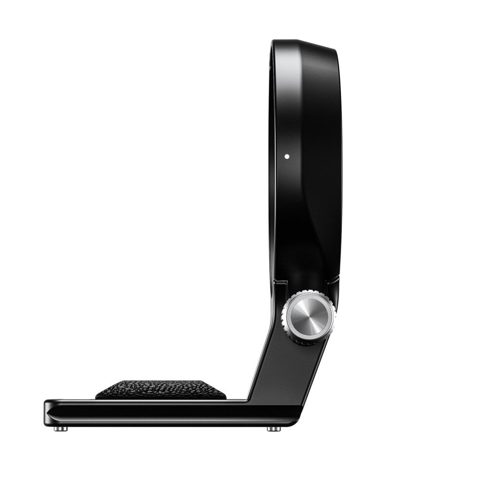 Side view of black lens collar with metal adjustment knob and textured grip pad on horizontal base.