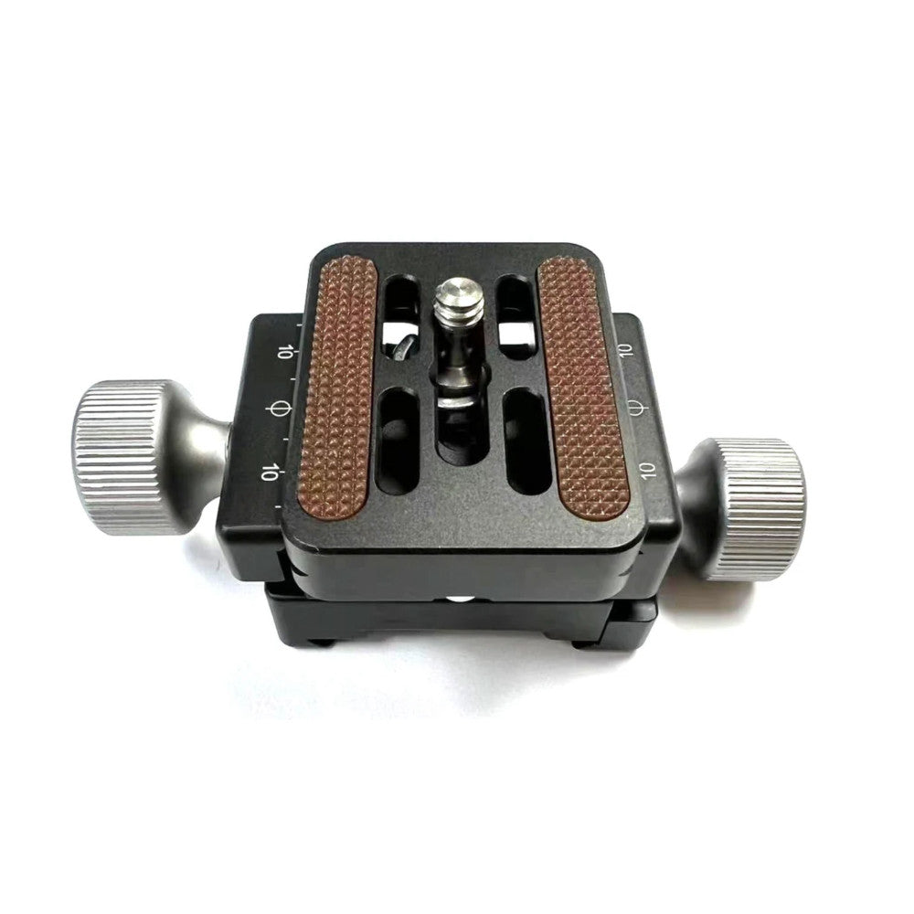 Top-down view of a black camera clamp with brown textured grip pads, dual silver adjustment knobs on sides, and central mounting mechanism on white background.