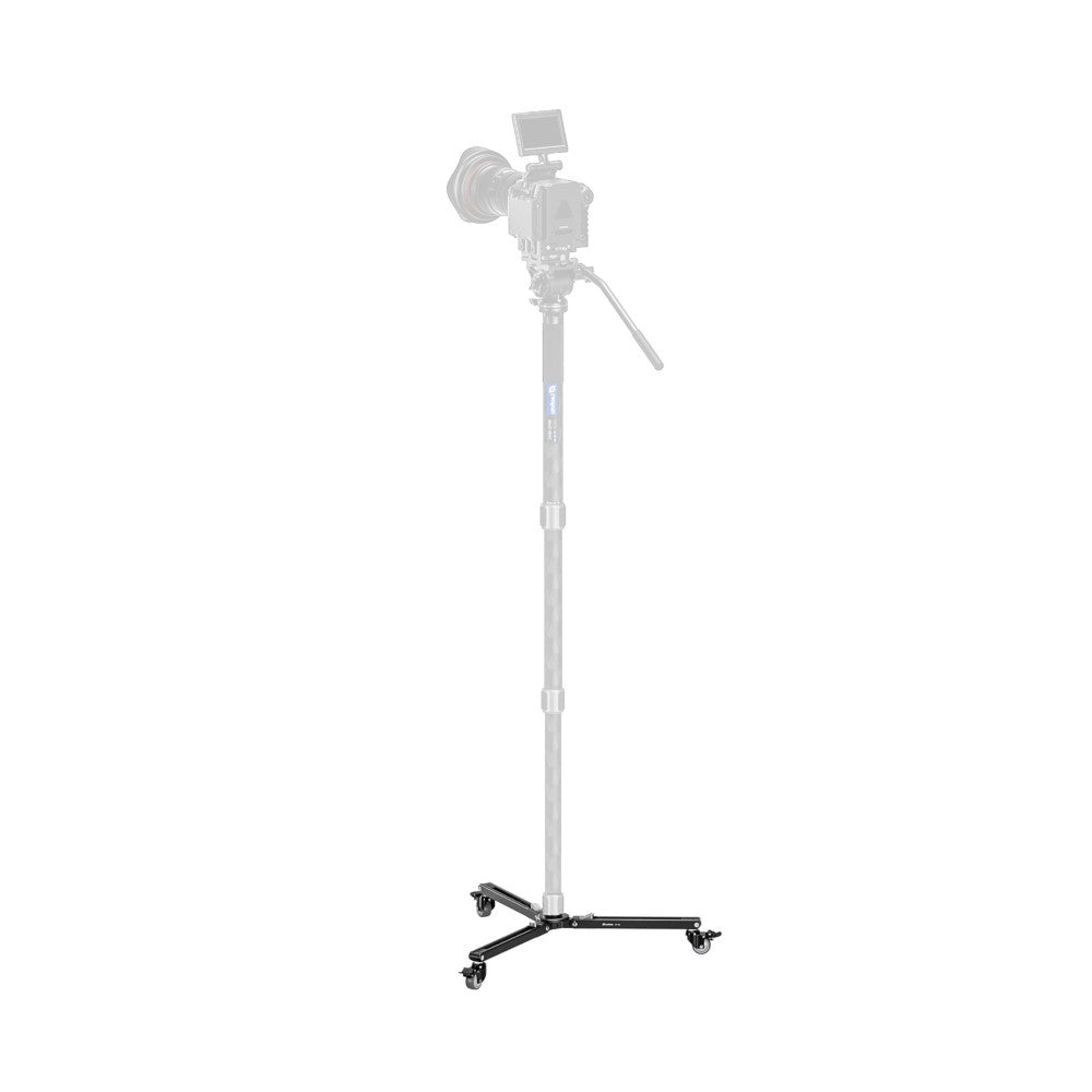 Front three-quarter view of a black wheeled dolly base with three casters, designed to support a tall monopod with camera mounted on top.