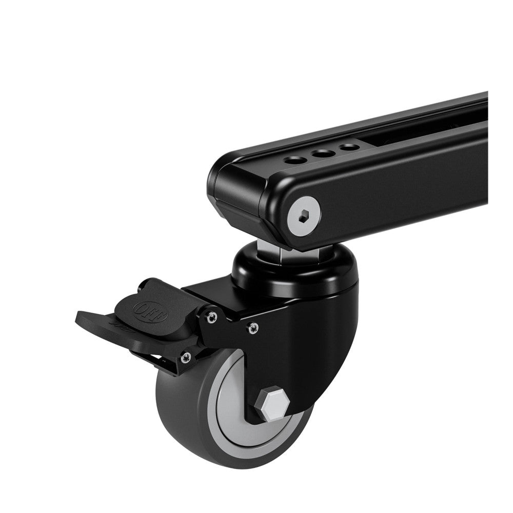 Close-up side view of black dolly wheel assembly with foot brake lever and mounting bracket for monopod attachment.