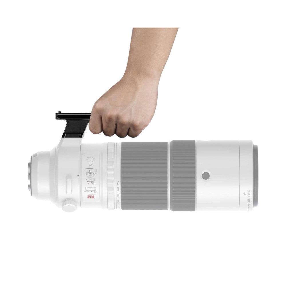 Hand demonstrating attachment of black lens foot to white telephoto lens, showing installation method from above.