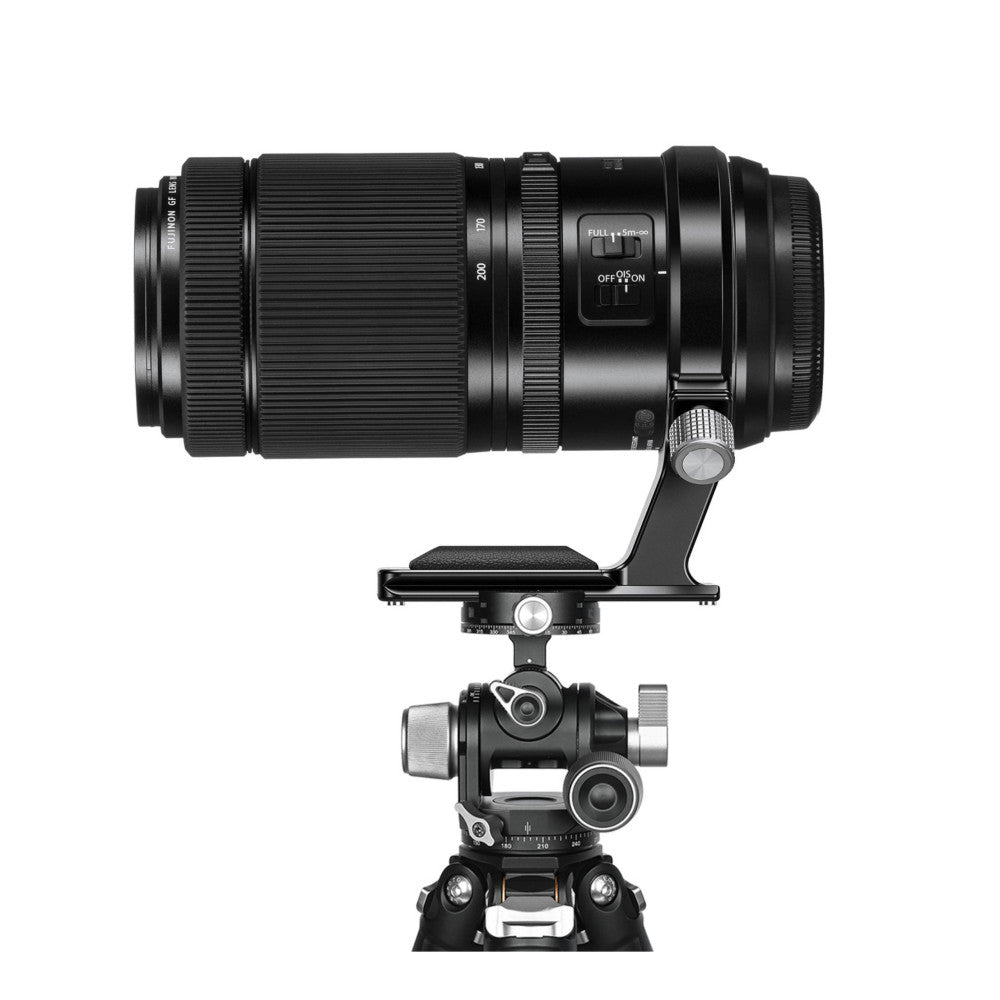 Telephoto lens mounted on a gimbal head and tripod, shown from the side in a vertical orientation setup.