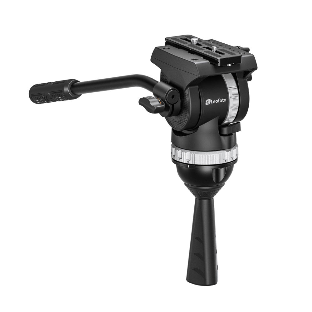 Black Leofoto video fluid head mounted on tripod leg, shown from side angle with pan handle extended and quick-release plate visible on top.