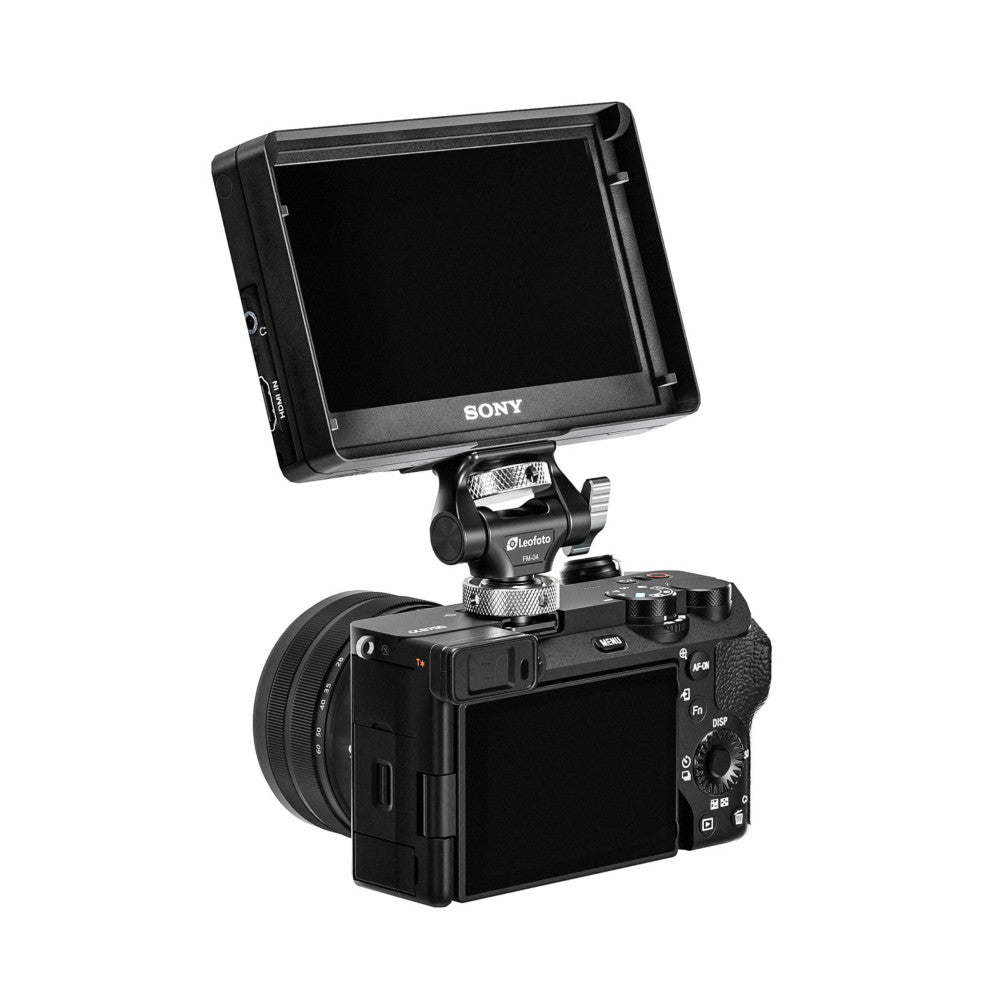 Sony monitor mounted on a Leofoto ball head attached to a compact camera, shown at an angled view demonstrating the setup in use.