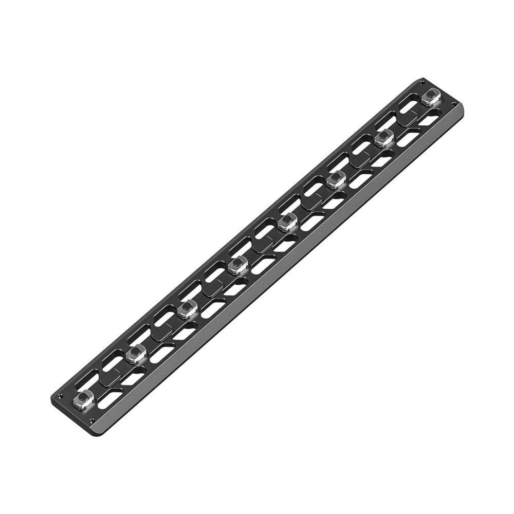 Black M-LOK quick release plate with metal mounting knobs, shown at an angled perspective view against white background.