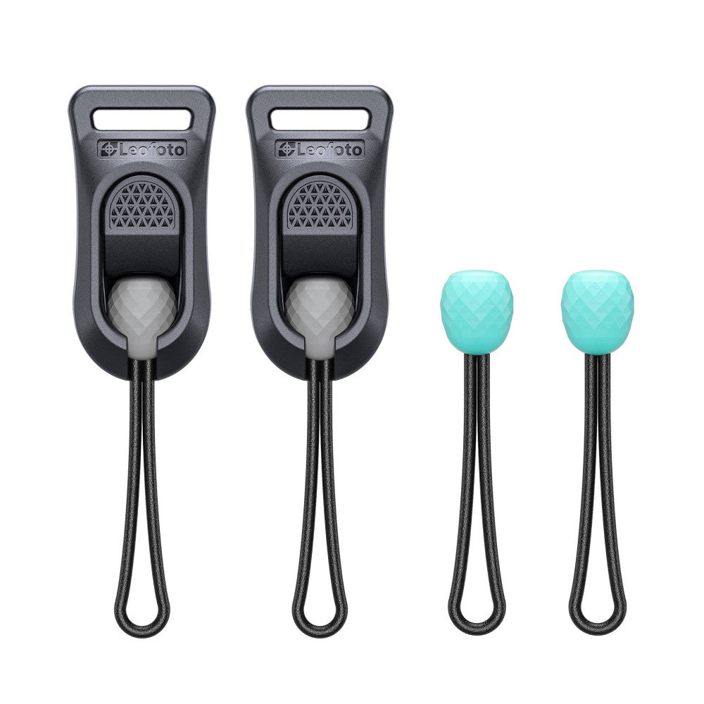 Four camera strap attachment components displayed: two black plastic quick-attach bases with textured grips and two turquoise rubber connectors with matching black cords.