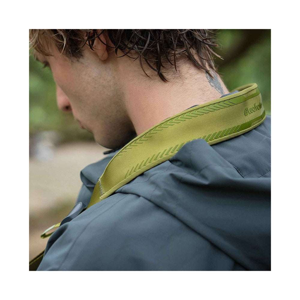 Close-up of pine green camera strap worn around person's neck and shoulder, showing textured neoprene material and stitching detail.