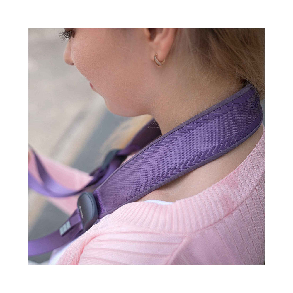 Purple camera strap worn around person's neck, showing quilted texture and grip detail in close-up side view.