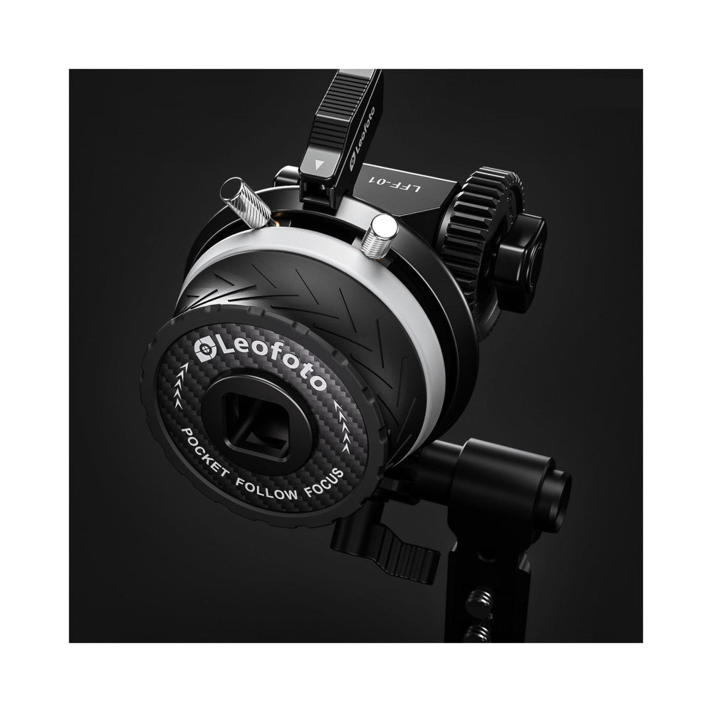 Overhead angled view of the Leofoto LFF-01 follow focus system showing the circular focus wheel with textured grip, control arms, and mounting bracket against a black background.
