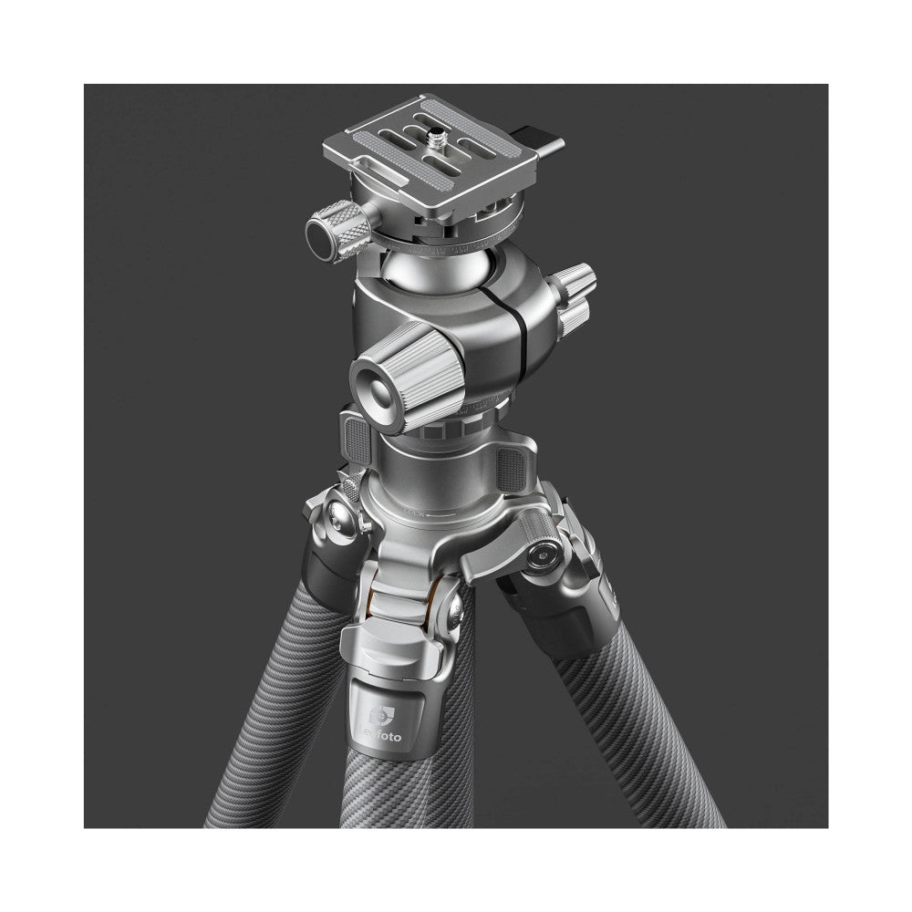Exploded view of silver Leofoto tripod showing stacked components including carbon fiber legs, ball head with pan handle, and quick-release plate against gray background.