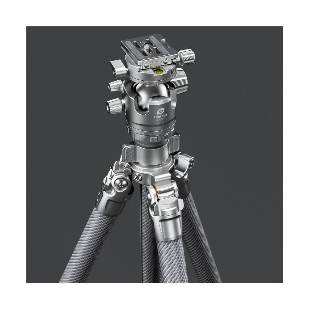 Professional tripod with silver ball head mounted on carbon fiber legs, shown from front-angled view against gray background.