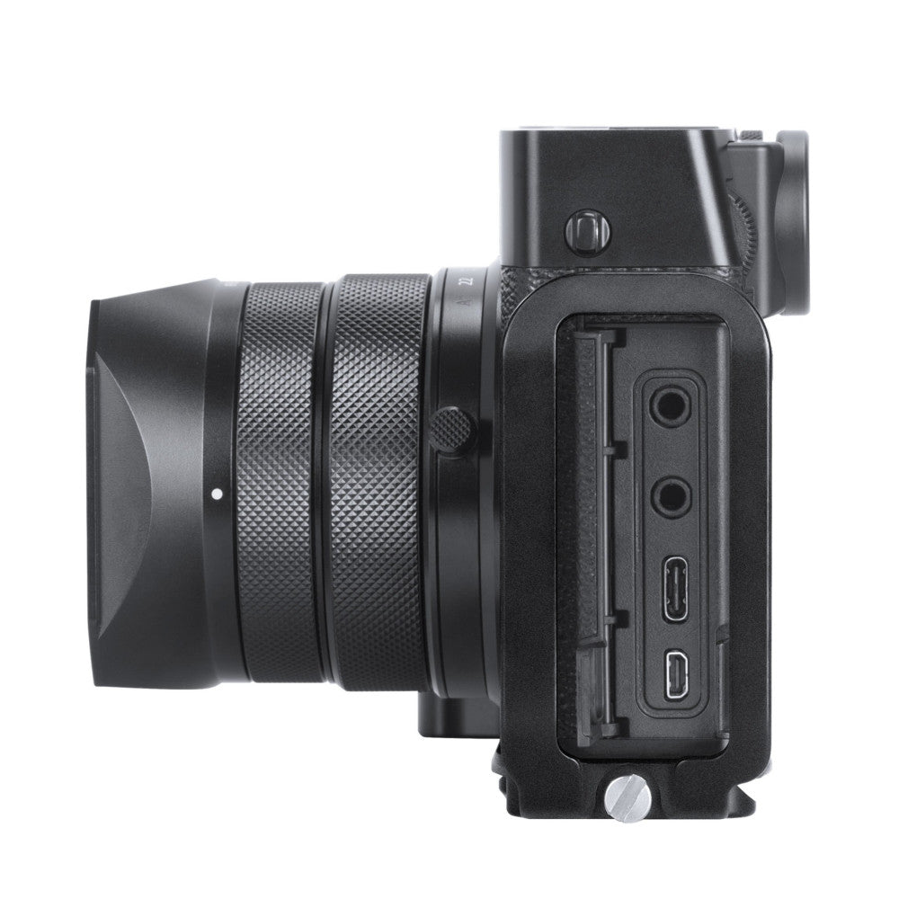 Black L-bracket mounted on Fujifilm GFX100RF camera body, side view showing grip and connection ports.