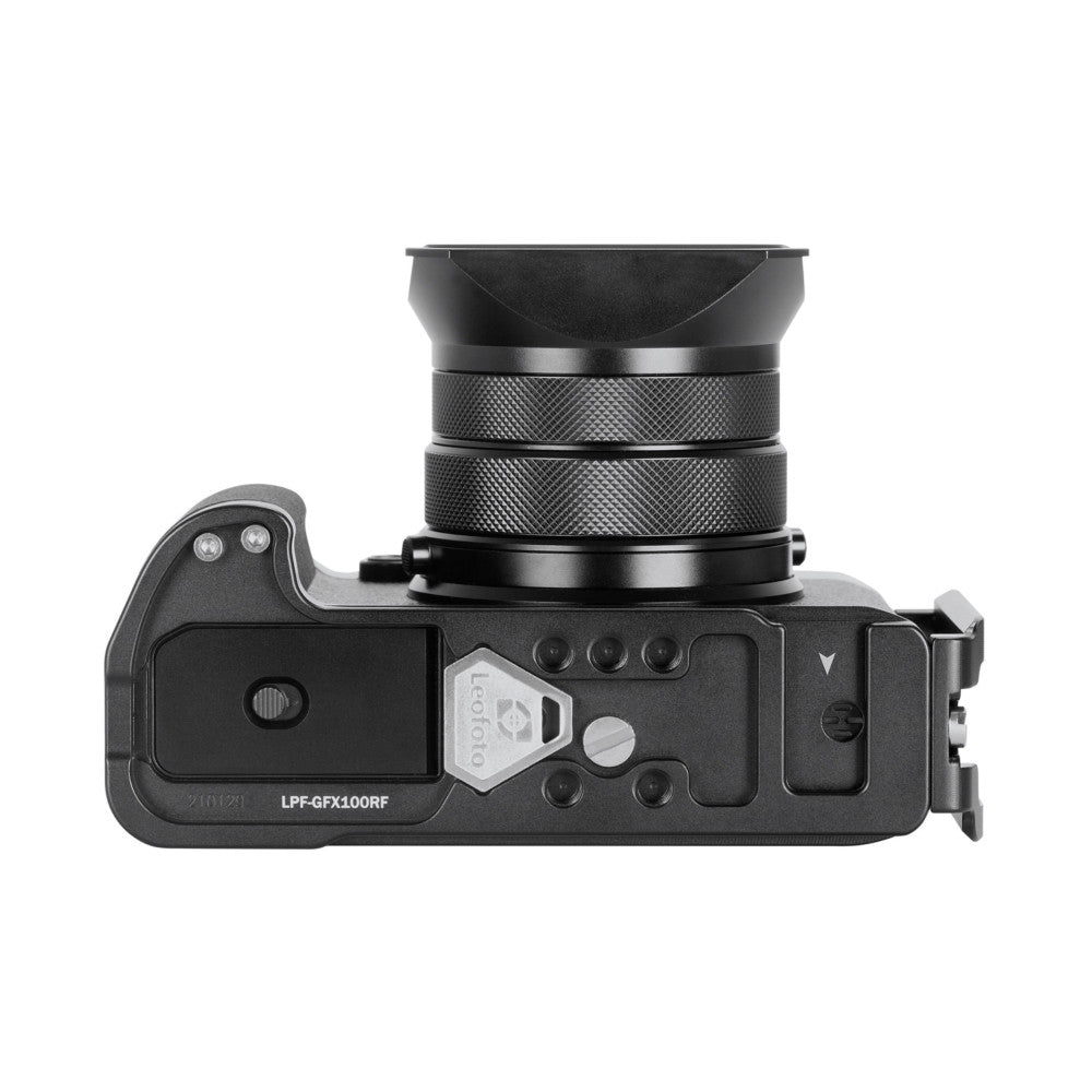 Top-down view of black L-bracket showing grip, control buttons, and attached lens plate with textured knurled rings.