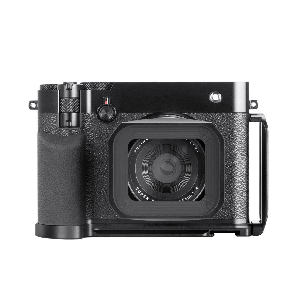 Black L-bracket mounted on Fujifilm GFX100RF camera, front-facing view showing textured grip surface and camera lens detail.