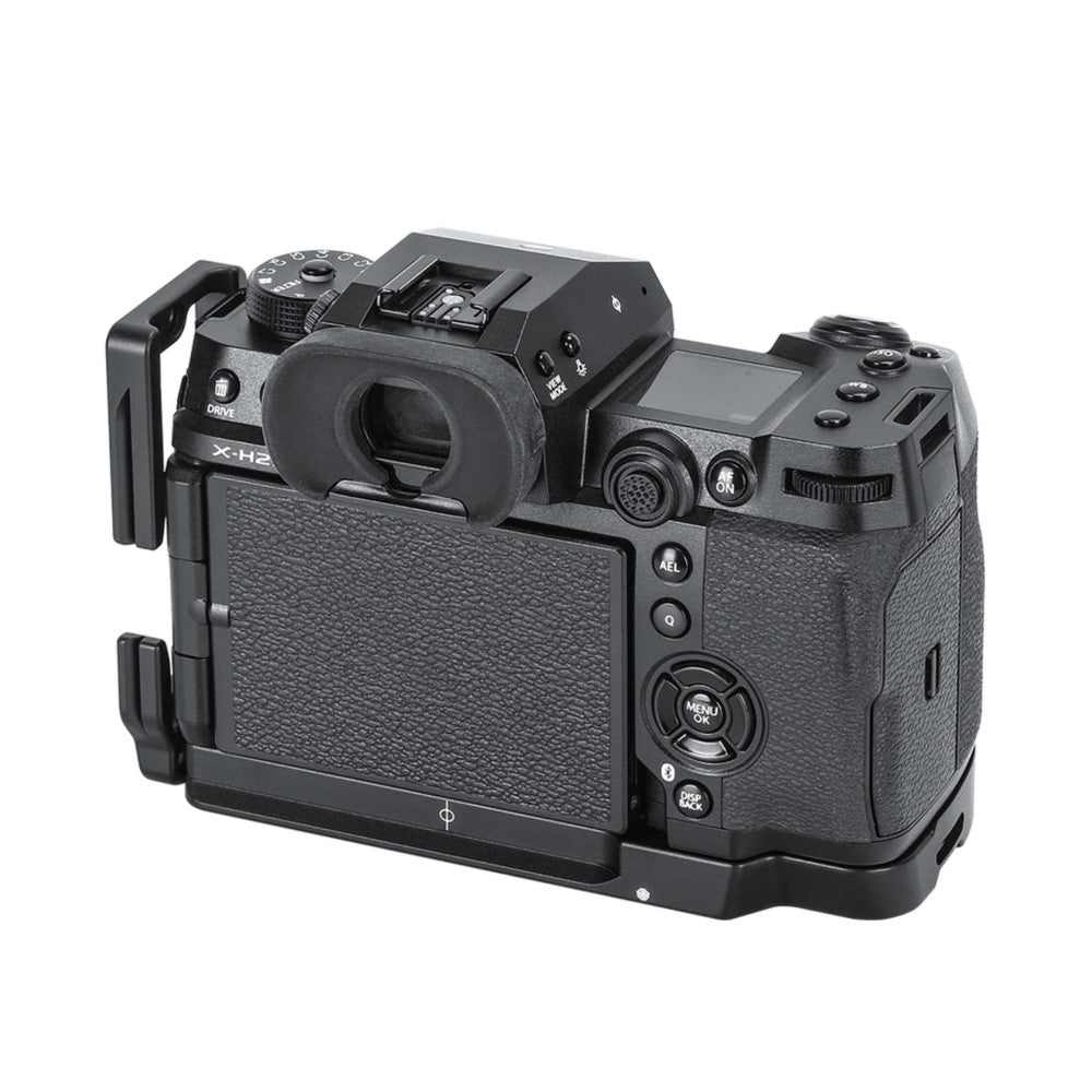 Black L-bracket mounted on Fujifilm X-H2 camera, shown from rear three-quarter angle displaying the bracket's grip and camera controls.