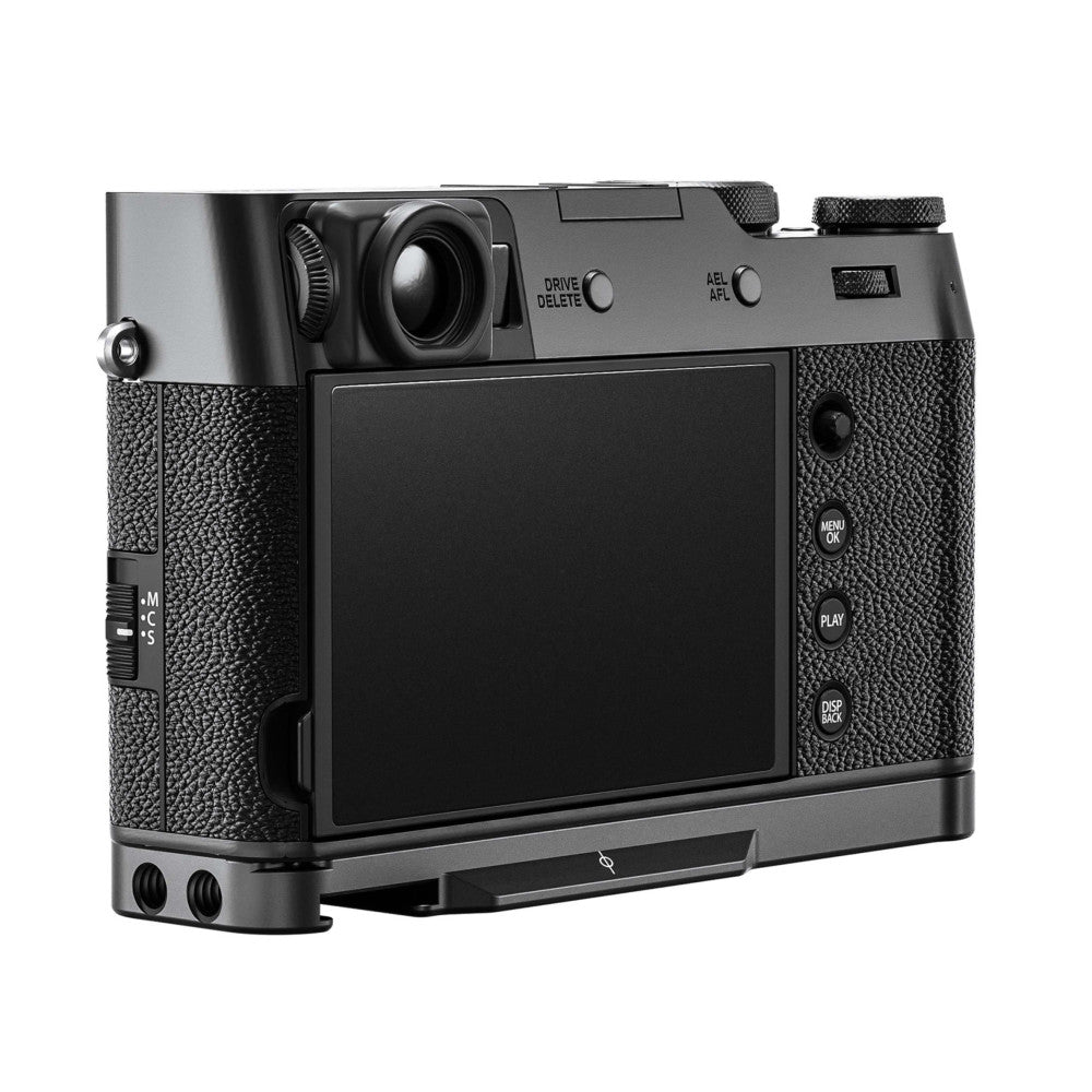 Rear three-quarter view of black L-bracket mounted on Fujifilm X100VI camera, showing LCD screen and control buttons.