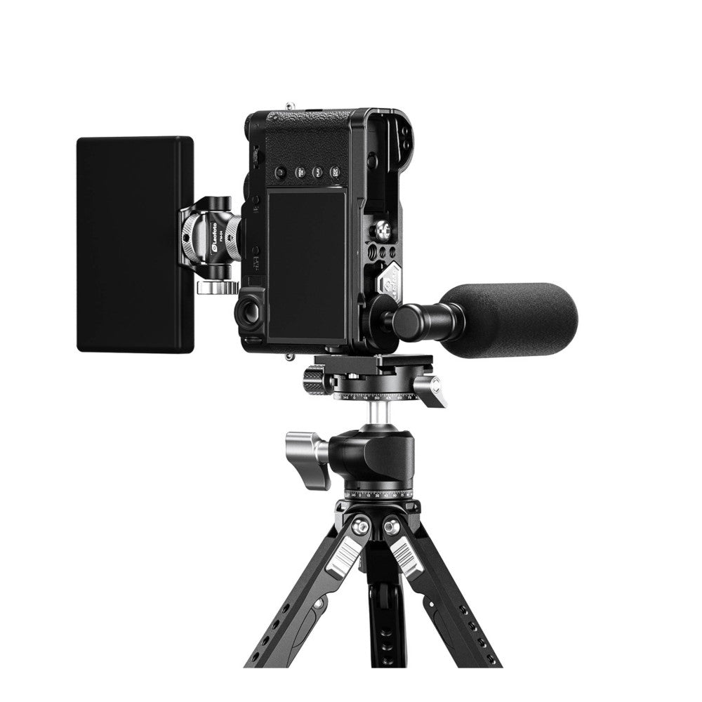 Black camera L-bracket mounted on tripod with microphone and external monitor attached, shown from front angle.
