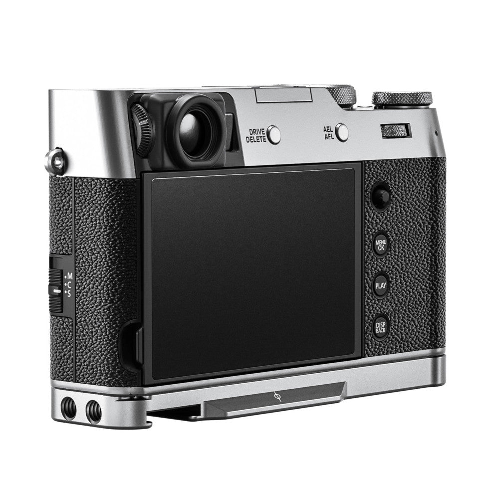 Rear three-quarter view of silver L-bracket mounted on Fujifilm X100VI camera, showing textured black grip sides and LCD screen.