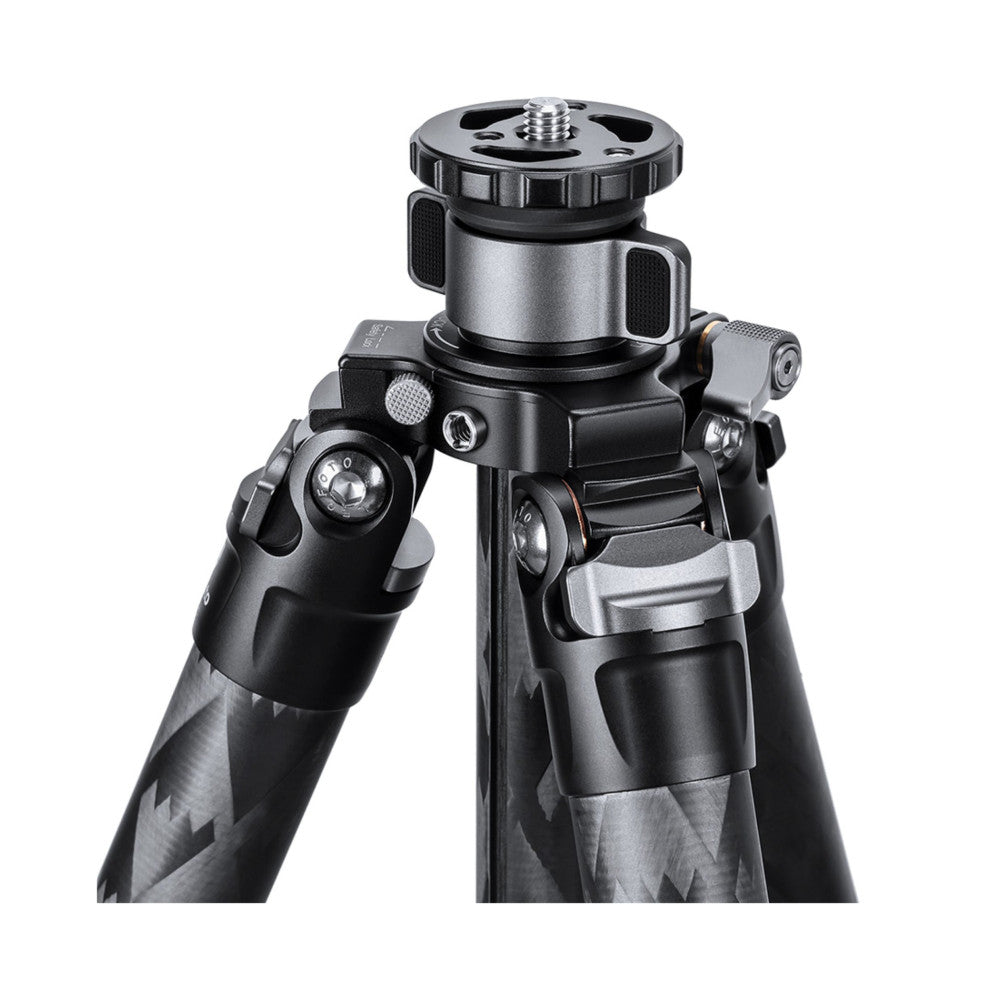 Carbon fiber tripod with ball head mounted on top, shown at an angle against white background displaying the leg locks and adjustment mechanisms.