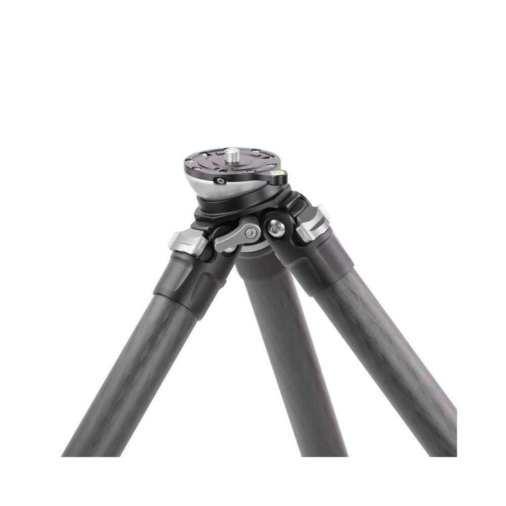 Close-up front view of tripod head and upper sections showing black carbon fiber legs, metal ball head with leveling base, and 1/4" mounting thread.