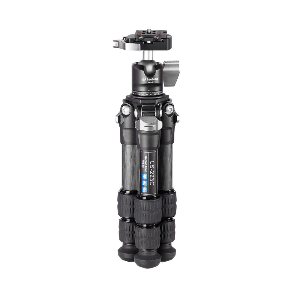 Front view of a black carbon fiber tripod with ball head mount, showing extended legs and adjustment controls against white background.