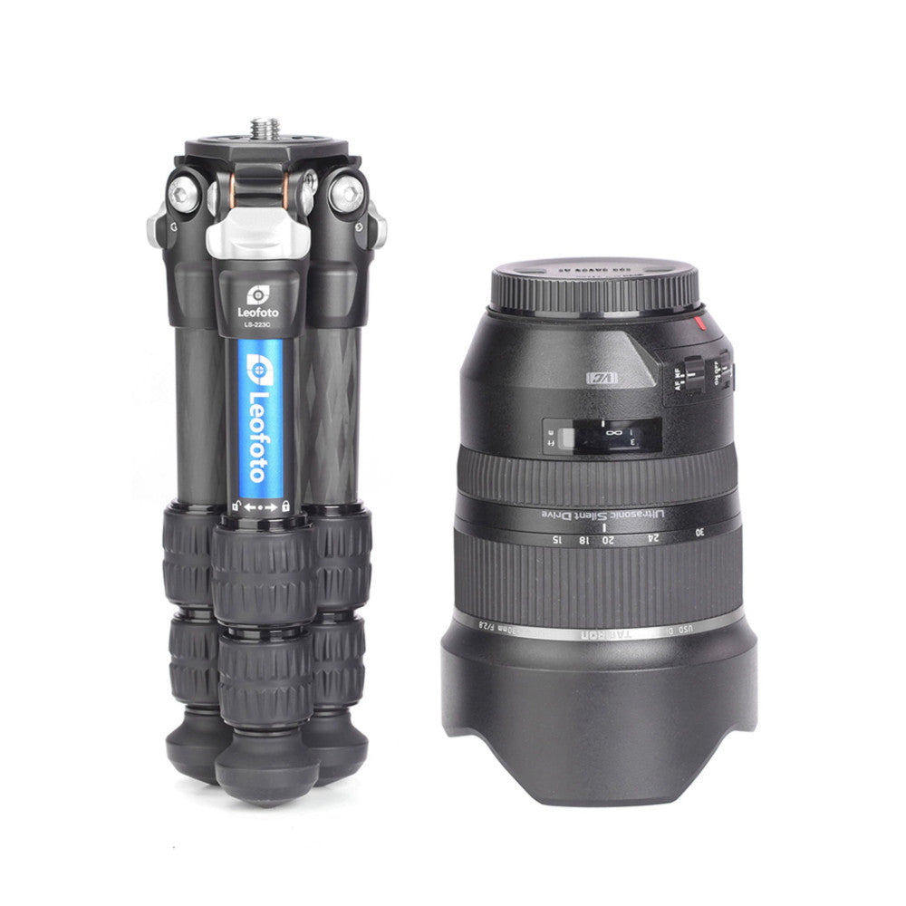 Leofoto LS-223C tripod head with extended legs next to a telephoto lens, shown in product comparison view.