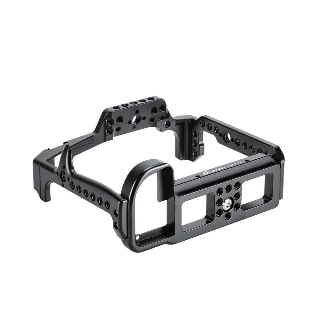 Black aluminum camera cage with multiple mounting holes and handles, shown in a three-quarter view against a white background.