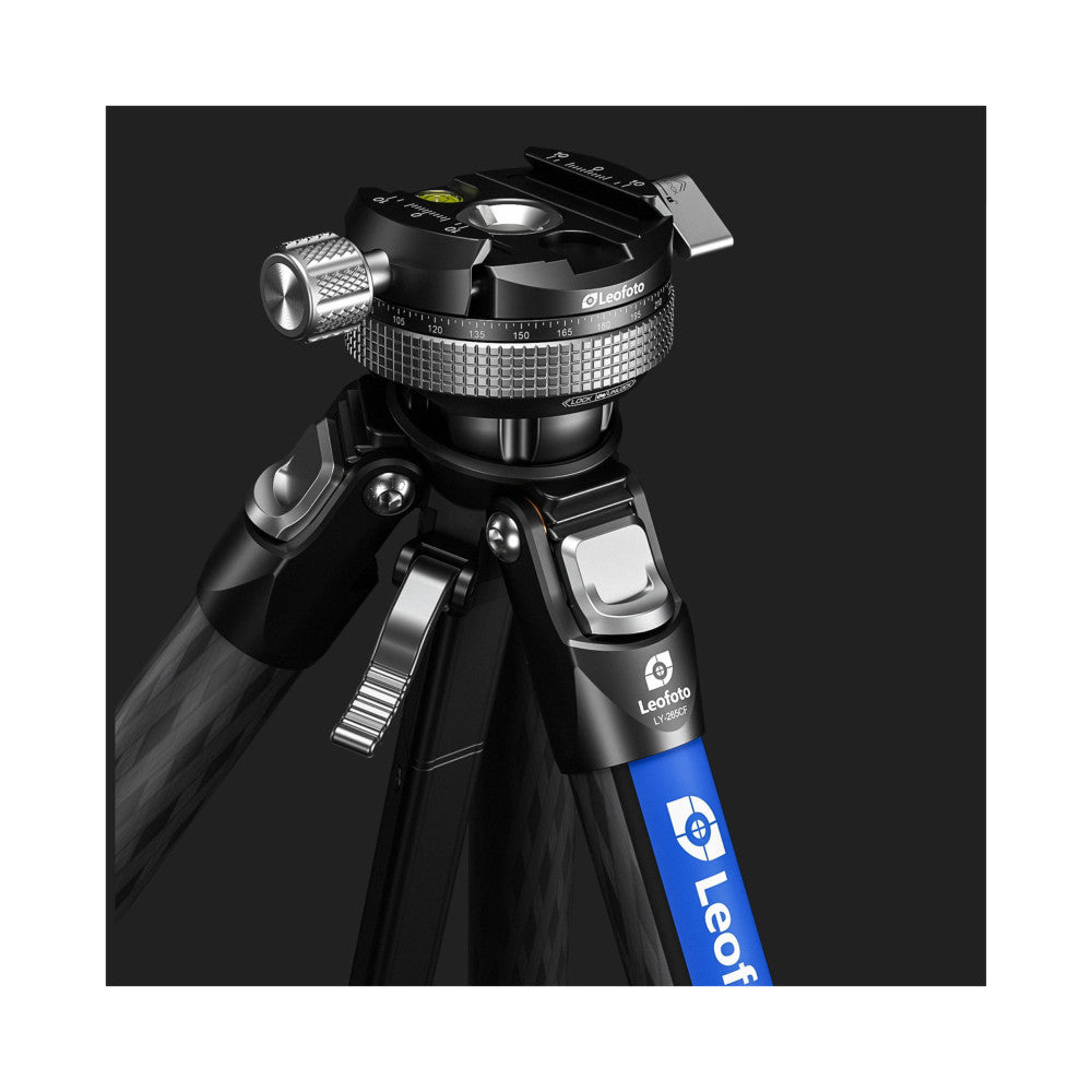 Professional tripod with ball head shown at an angle against dark background, displaying carbon fiber legs and metal components with blue branding stripe visible.
