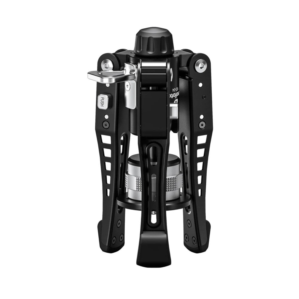 Front view of a black carbon fiber video monopod with extended legs, showing the central column, flip locks, and metal fluid head mount.