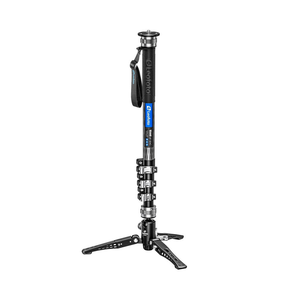 Black and blue carbon fiber monopod with tripod base, shown in full-length side view against white background, displaying ball head and leg spreaders.