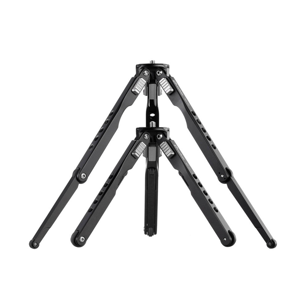 Front view of a compact black tripod with two leg sections extended, featuring ball head joints and adjustment knobs at the top.