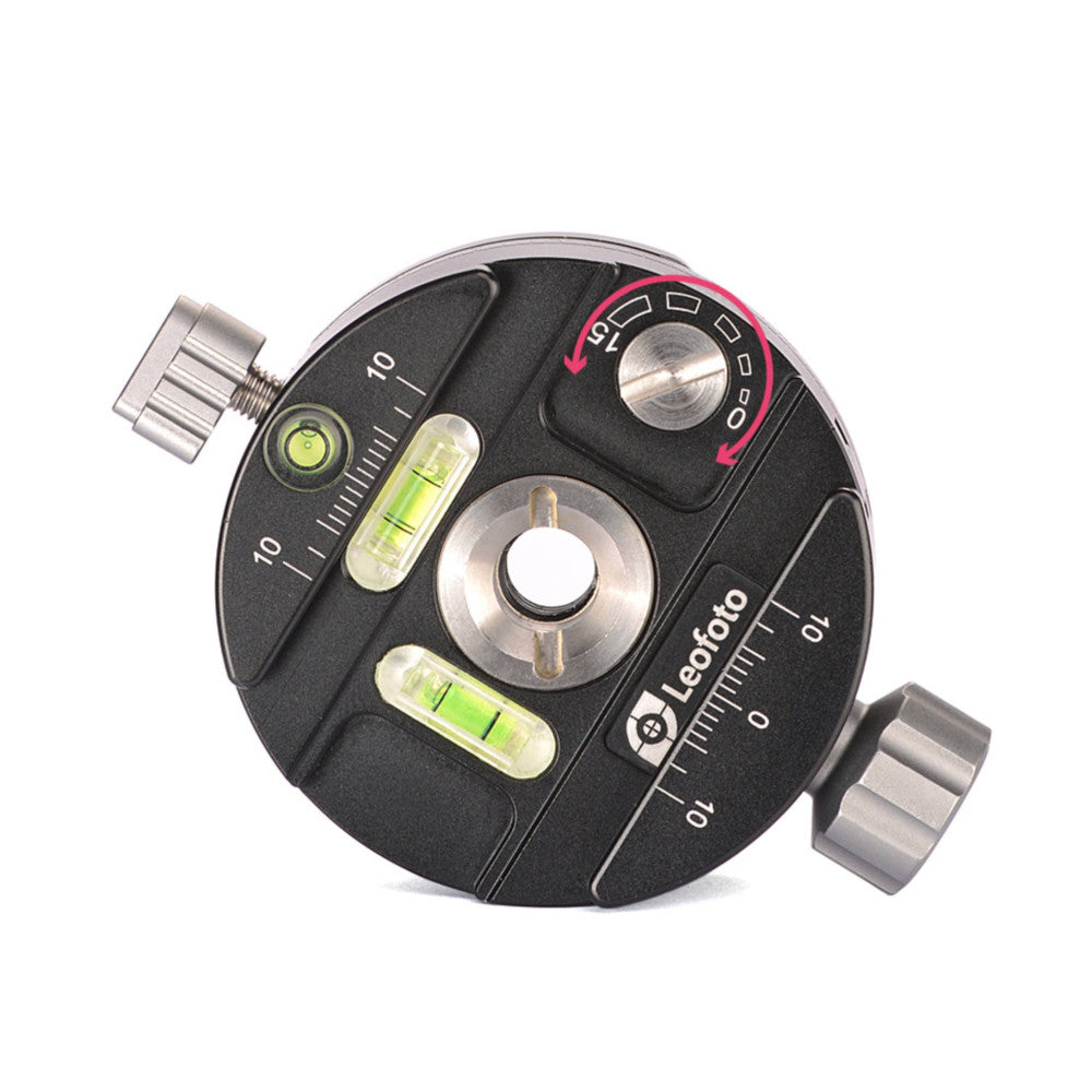 Top-down view of a black circular panning clamp with dual bubble levels, friction control knob, and metal quick-release plate attachment points.