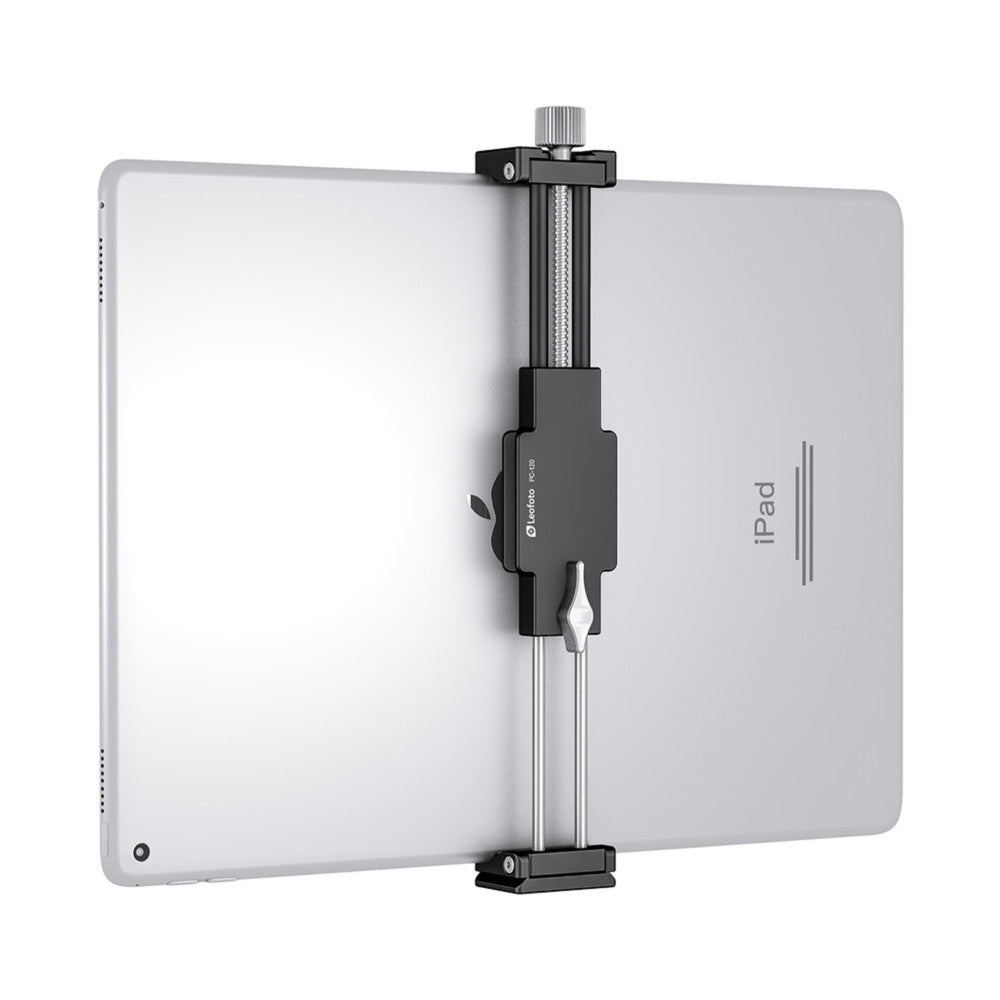 Black tablet holder clamp mounted on silver iPad, shown from front angle with adjustable screw mechanism and Arca Swiss foot base visible.