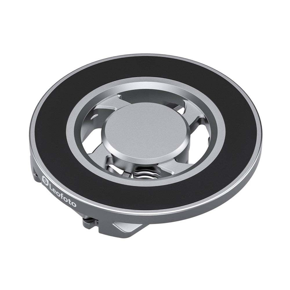 Top-down view of a circular silver and black magnetic quick mount plate with internal metal components visible through the center opening.