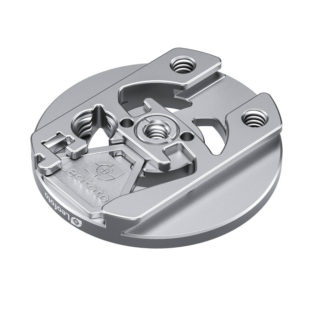 Top-down angled view of silver magnetic quick mount plate showing threaded mounting holes, metal contact surfaces, and internal locking mechanism.