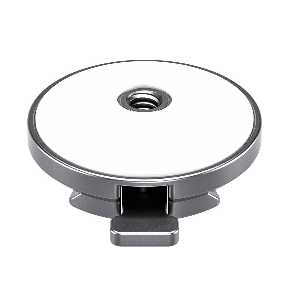 Top-down view of a silver magnetic car mount with a circular mounting plate, central spindle hole, and rectangular Arca-style quick-release plate base.