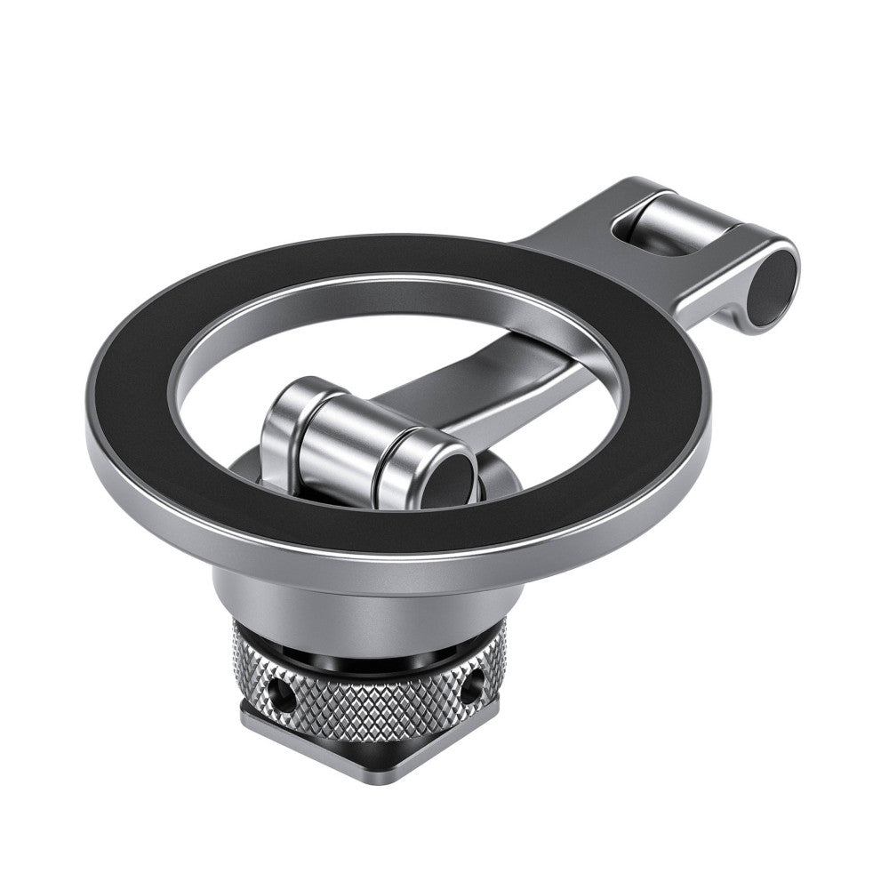 Isometric view of a silver magnetic phone mount with articulating arm and cold shoe base, showing the circular magnetic plate and mounting mechanism.