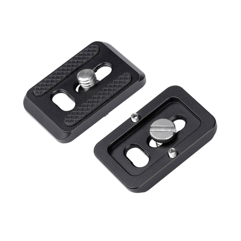 Two black Arca Swiss quick release plates shown from above at an angle, displaying mounting slots and threaded adjustment screws.