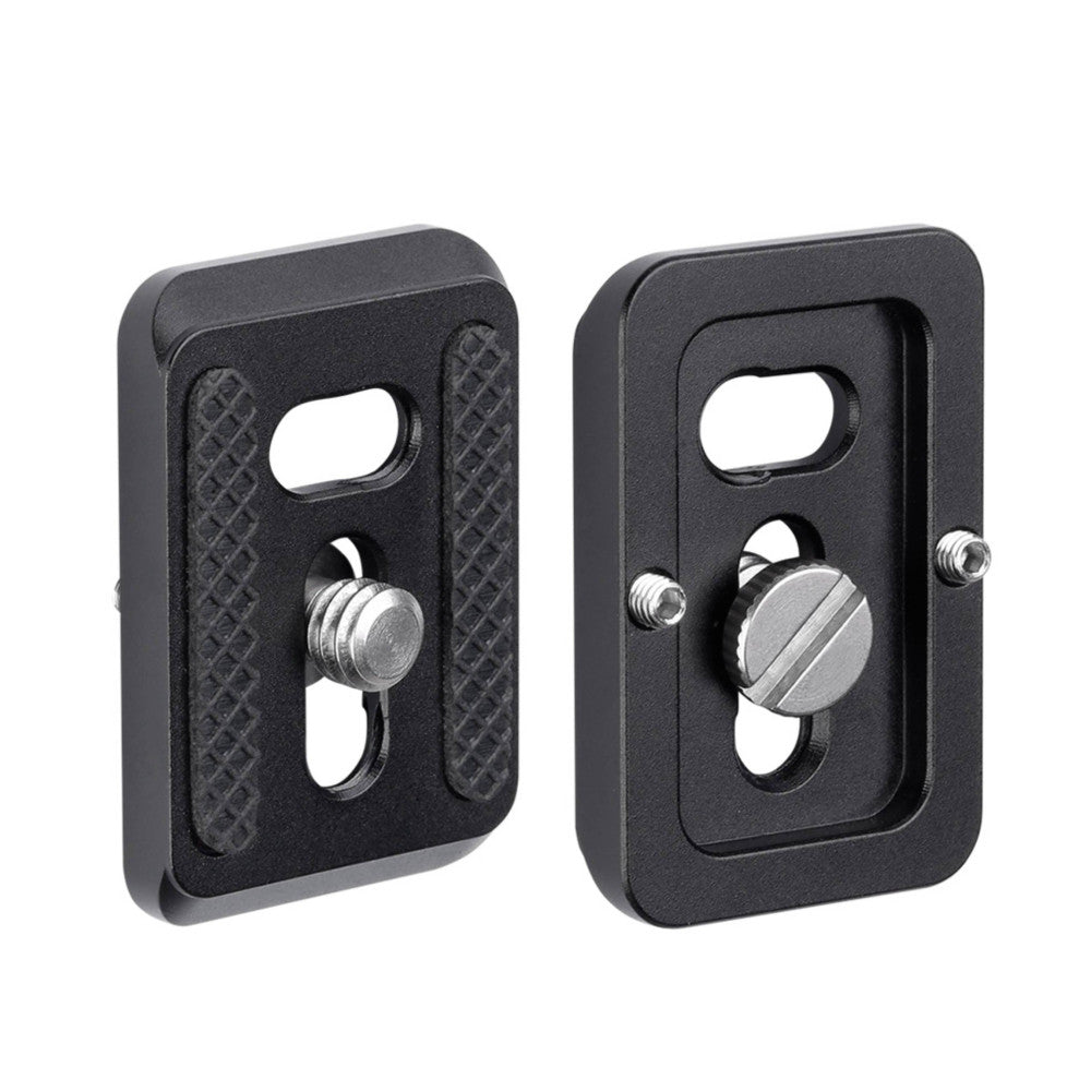 Two black Arca-Swiss quick release plates shown from front and rear angles, displaying the mounting surface and adjustment screw mechanisms.