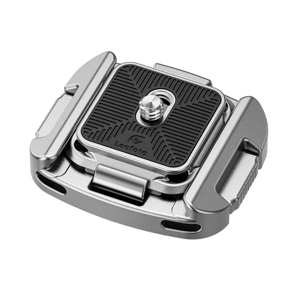Isometric view of silver Leofoto QF-01 Arca-Swiss quick release clamp showing top plate, adjustment knob, and side grip handles against white background.