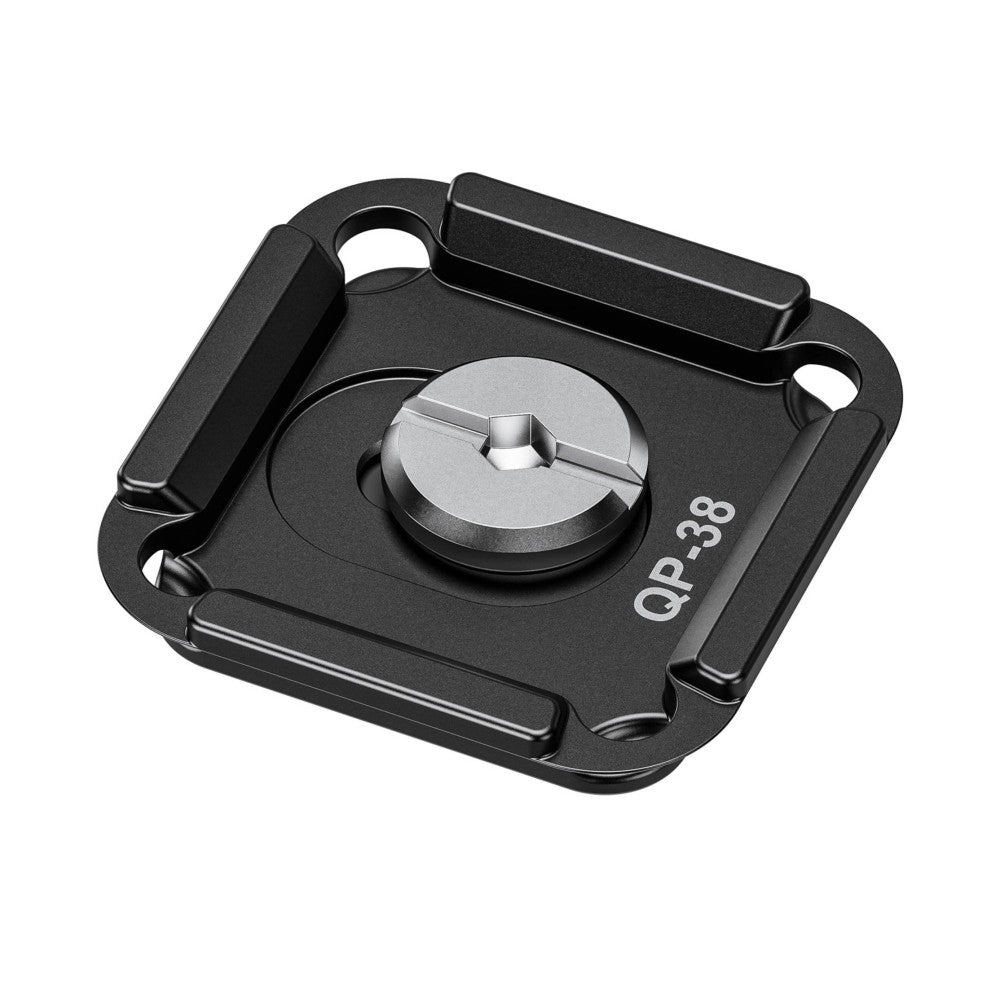 Top-down angled view of black QP-38 quick release plate showing the circular mounting surface with cross-slot and surrounding attachment points.