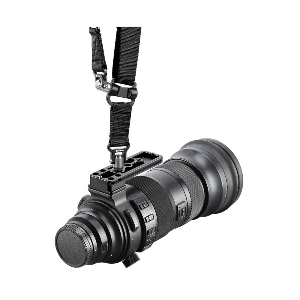 Black telephoto zoom lens with attached arca-swiss lens foot and shoulder strap, shown at angle against white background.