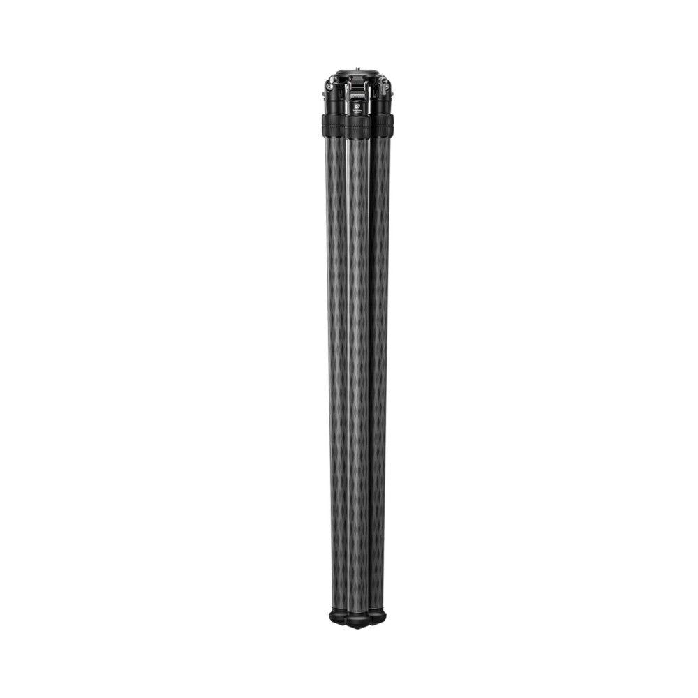 Extended carbon fiber tripod shown fully collapsed in vertical position against white background, displaying black head assembly and grip sections.