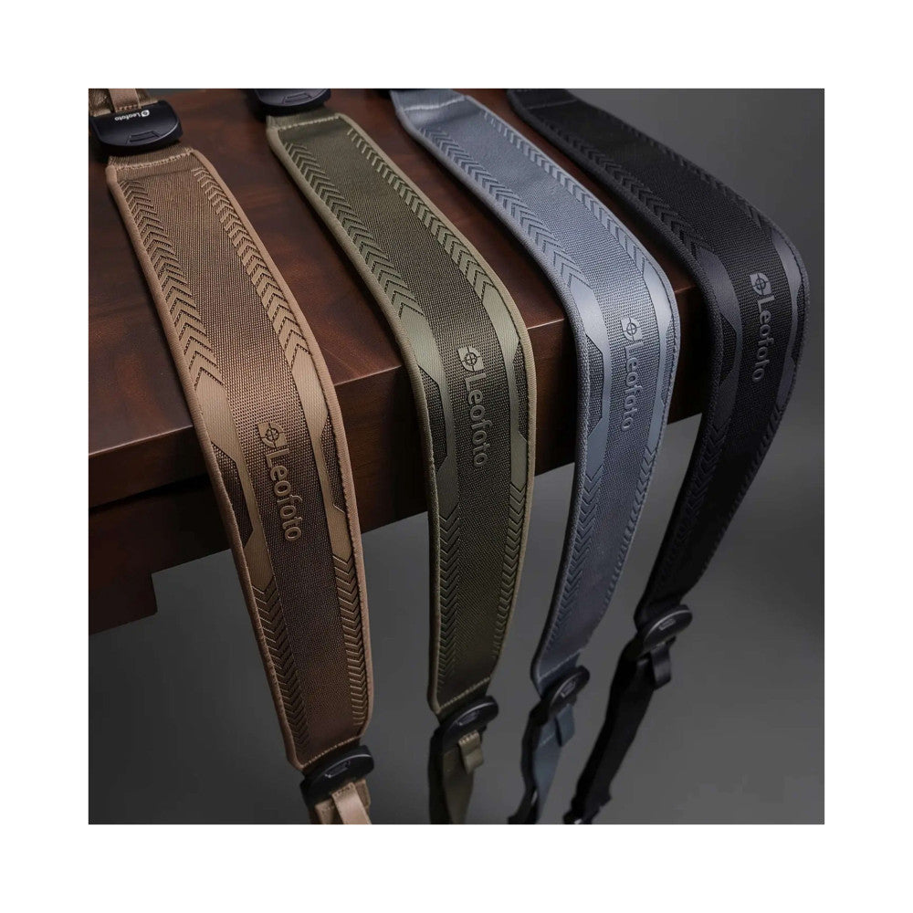 Four camera straps in different colors displayed side-by-side showing herringbone weave pattern and branding details.