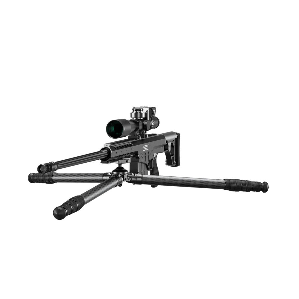 Black carbon fiber tripod with integrated ballhead supporting a tactical rifle equipped with a scope, shown from a side angle against a white background.