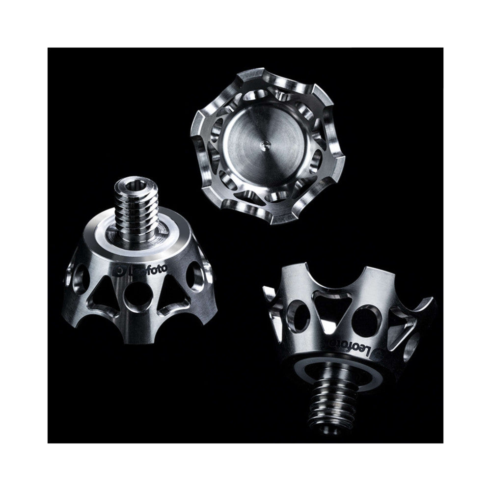 Three metallic tripod claw attachments shown disassembled against a black background, displaying threaded components and mounting details from different angles.