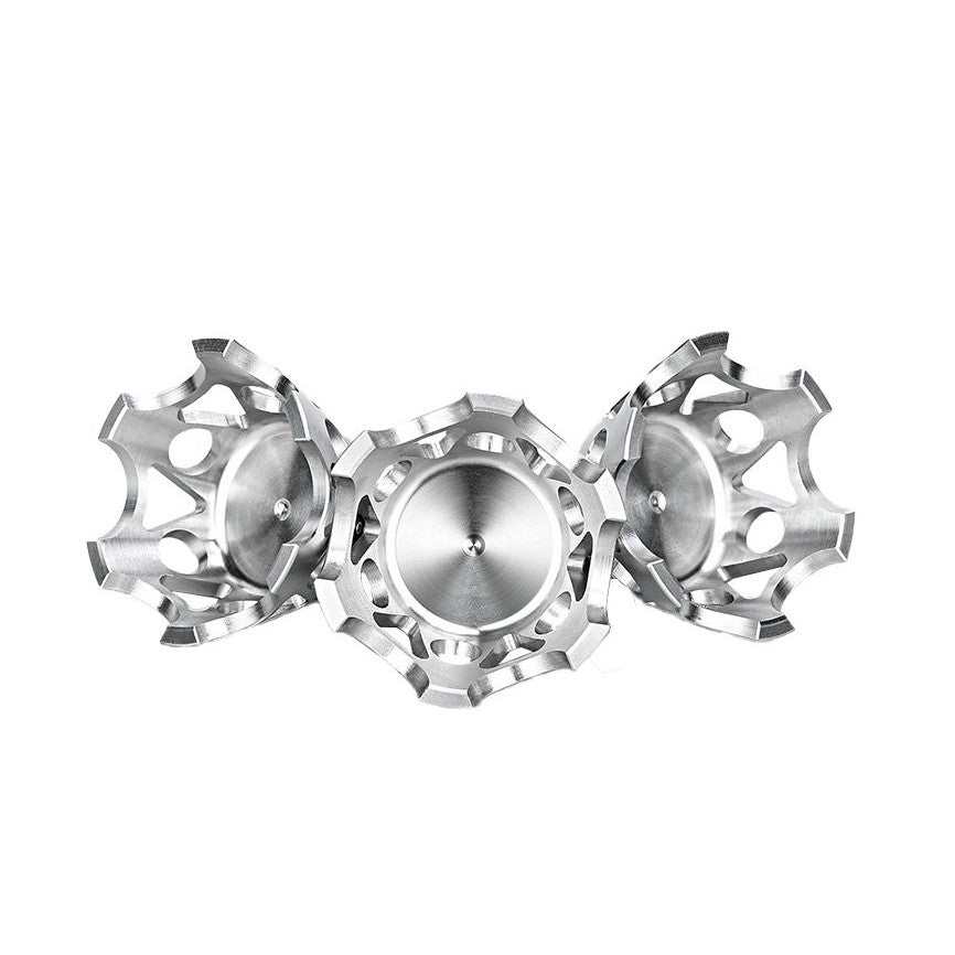 Three metallic tripod claws with serrated edges arranged in a symmetrical pattern, center claw facing forward, side claws angled outward, showing top view detail.