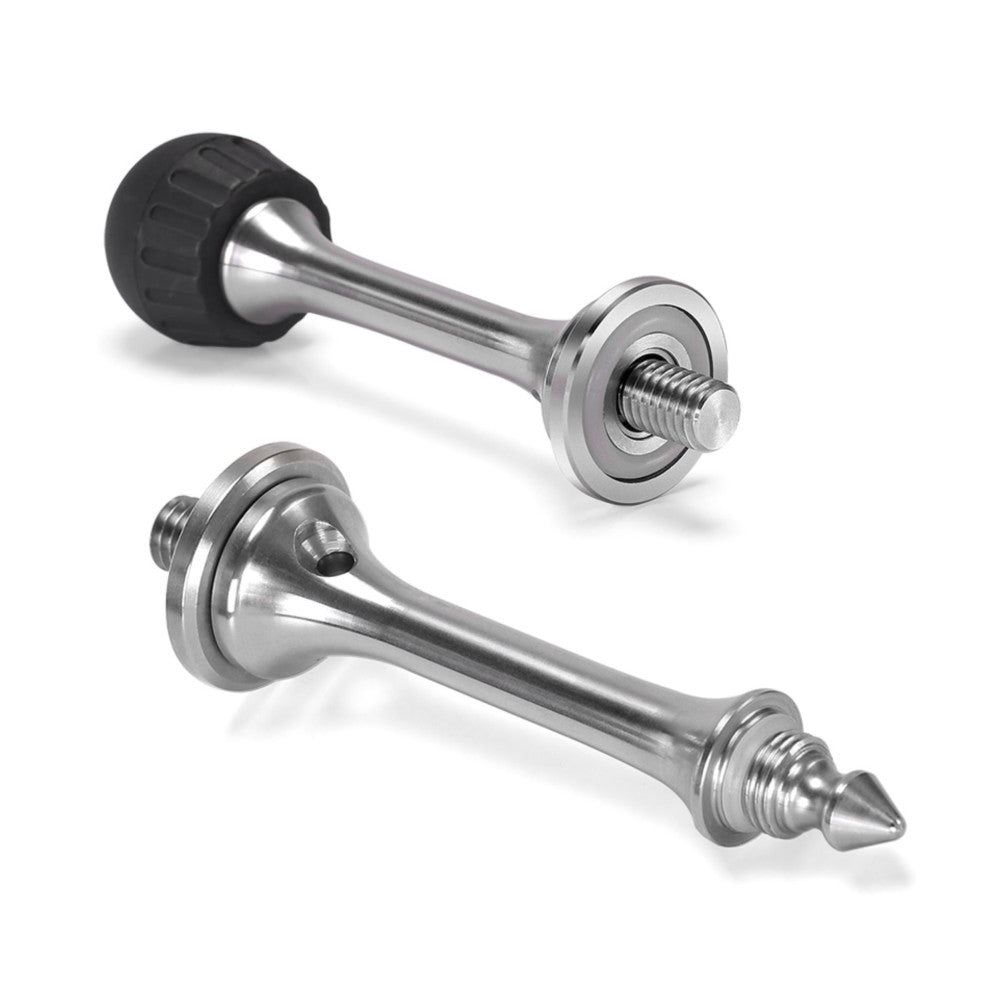 Three metal tripod foot spikes with threaded bases shown at different angles, including one with a black rubber cap attached.